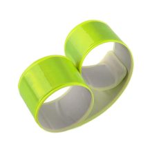 Jól látható, neon színű, önzáródó fényvisszaverő karpánt csuklón viselve sötétben.